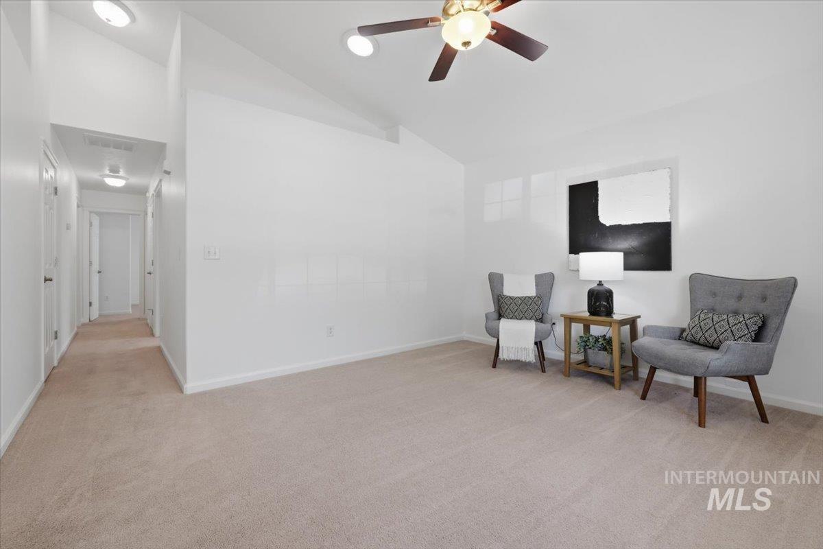 2075 North Springland Place Boise, ID 83713 - Photo 8 of 49 Spacious room featuring vaulted ceilings, recessed lighting, and a ceiling fan