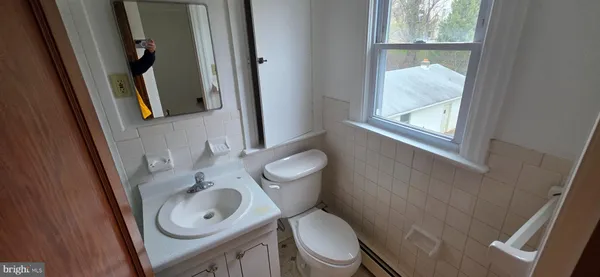 a white toilet sitting next to a bathroom sink