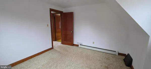 an empty room with windows and ceiling fan
