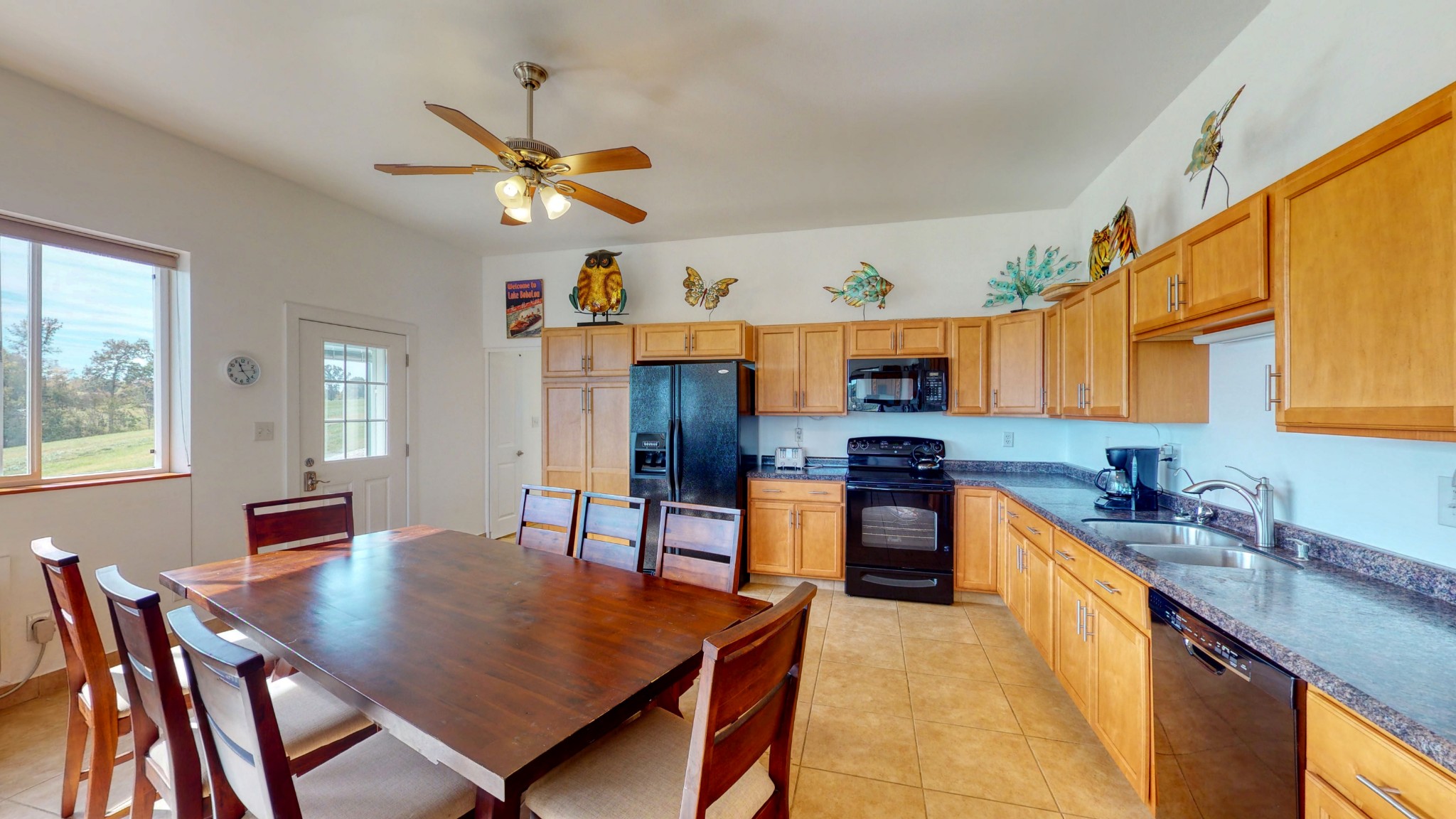 650 Humphrey Road Huntingdon, TN 38344 - Photo 6 of 24 a kitchen with stainless steel appliances granite countertop a stove a sink dishwasher a dining table and chairs with wooden floor