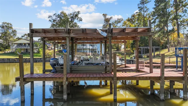 a view of a swimming pool with a patio and lake view