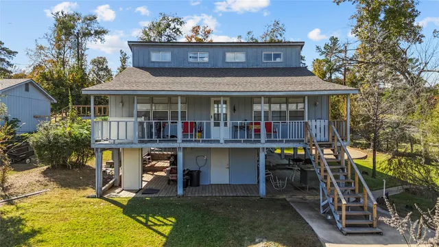 a view of house with swimming pool and sitting area