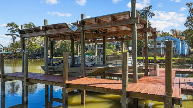 a view of a swimming pool with a porch and furniture
