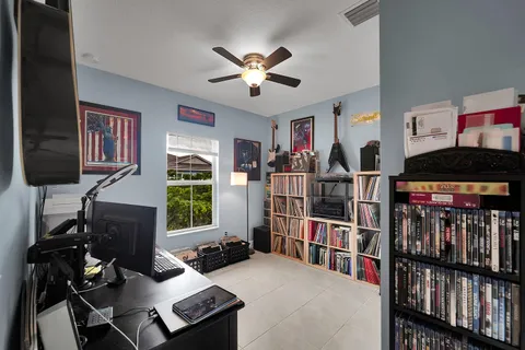 a living room with lots of furniture and a book shelf