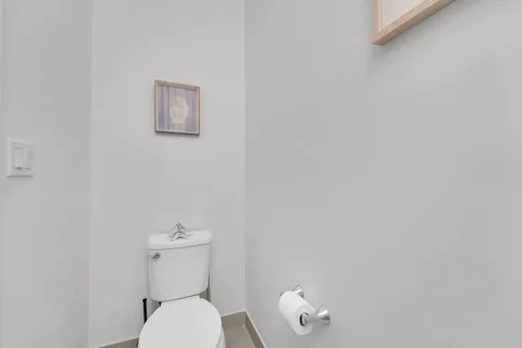 a white toilet sitting next to a white walls