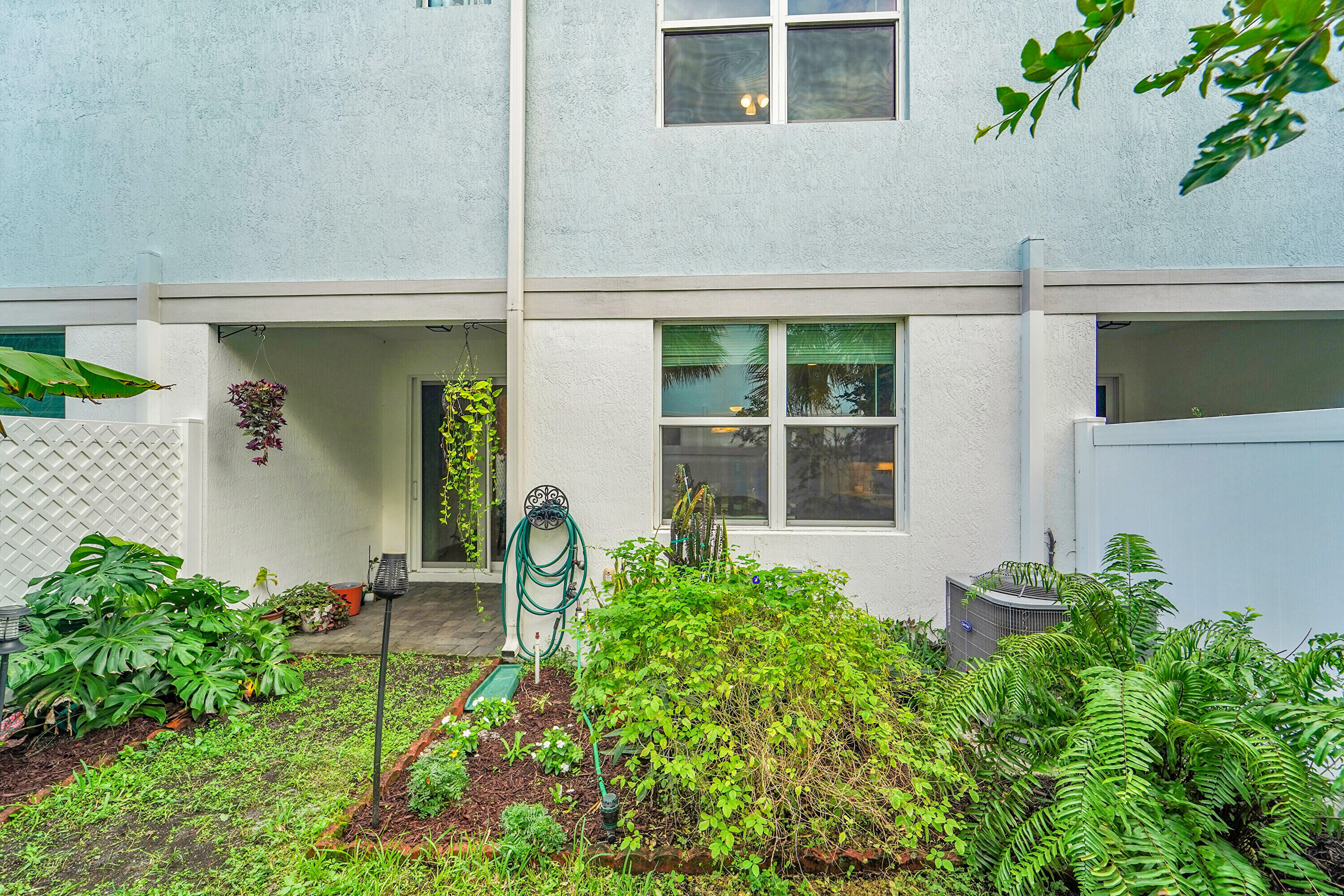 1821 Sandpiper Pointe Place, Unit 1821 Deerfield Beach, FL 33442 - Photo 24 of 24 a front view of a house with a yard