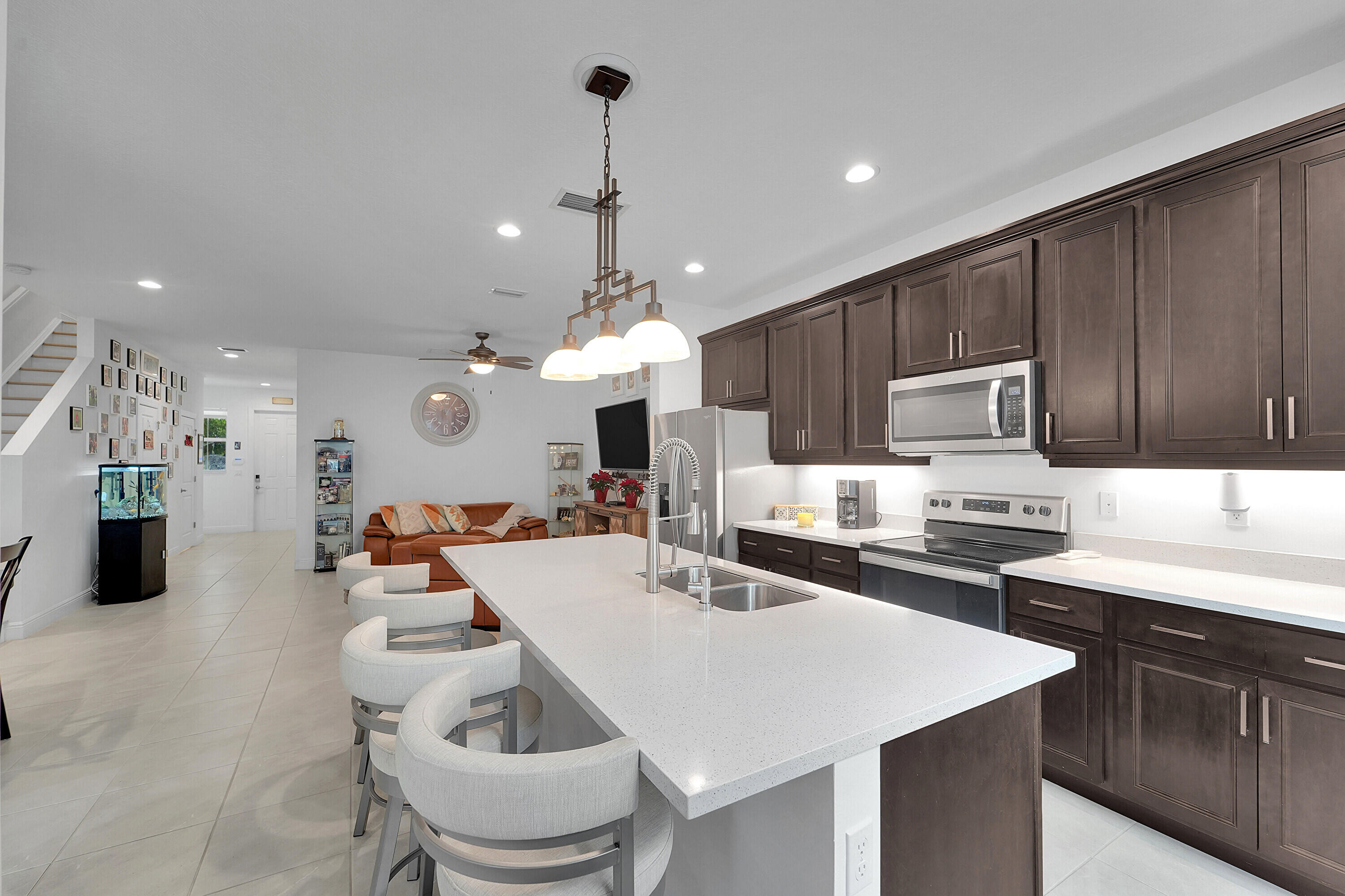 1821 Sandpiper Pointe Place, Unit 1821 Deerfield Beach, FL 33442 - Photo 4 of 24 a kitchen with granite countertop a sink stove and refrigerator