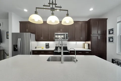 a kitchen with stainless steel appliances a refrigerator and fireplace