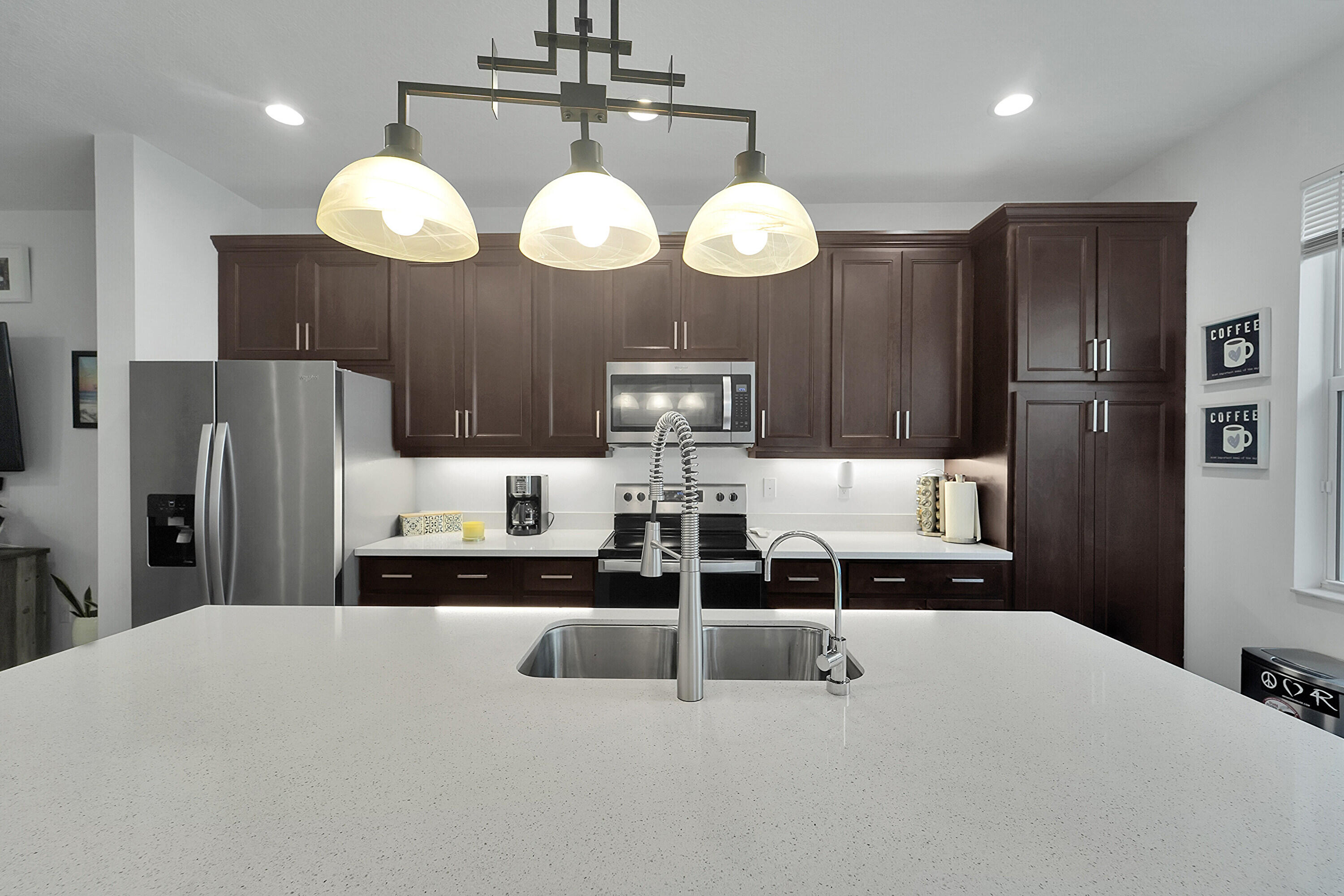 1821 Sandpiper Pointe Place, Unit 1821 Deerfield Beach, FL 33442 - Photo 5 of 24 a kitchen with stainless steel appliances a refrigerator and fireplace