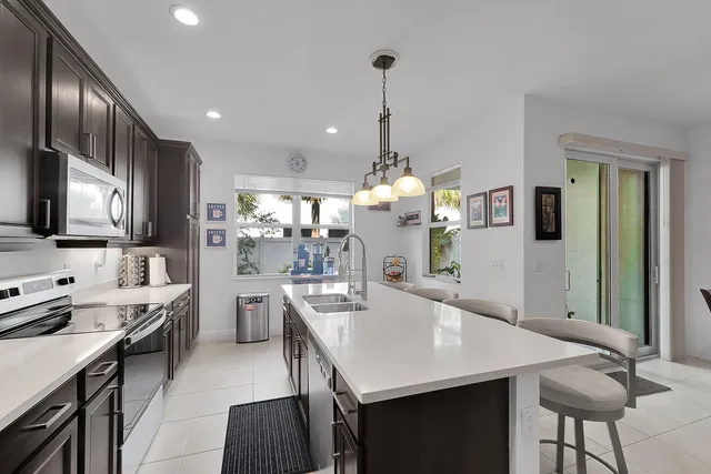 a large kitchen with a table and chairs
