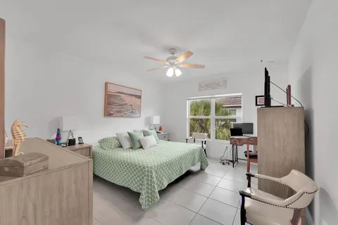 a bedroom with a bed and a large window