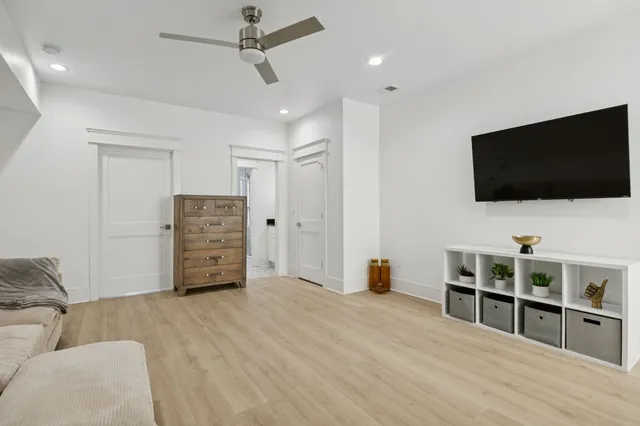 a kitchen with stainless steel appliances kitchen island a table chairs refrigerator and microwave