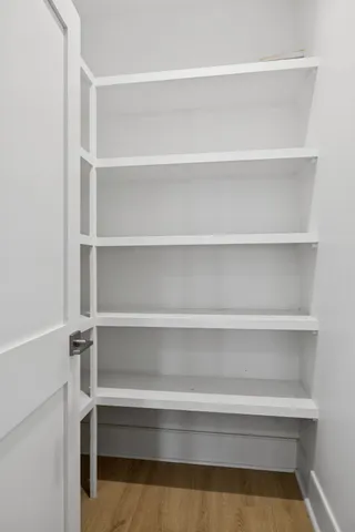 a living room with furniture a rug and kitchen view