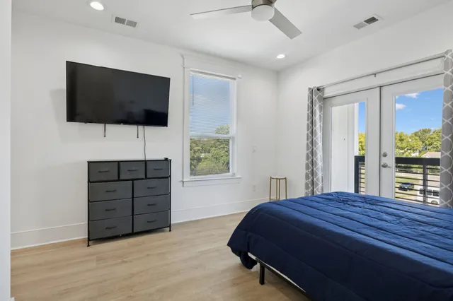 a bedroom with furniture a flat screen tv and a fireplace