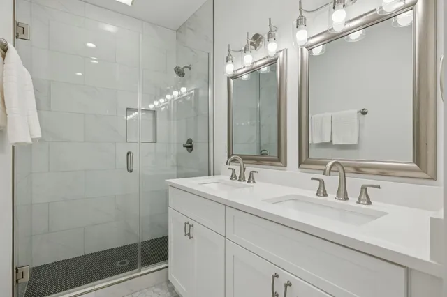 a bathroom with a sink a toilet and shower