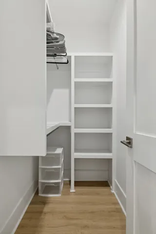 a living room with stainless steel appliances furniture and a window