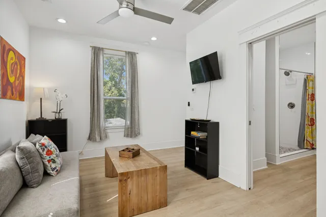 a view of a hallway with wooden floor and closet area