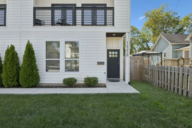 a living room with a bed and a window