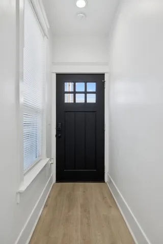 a bedroom with a bed and a flat tv screen on dresser