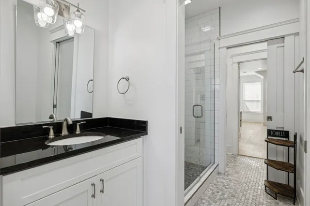a bathroom with a sink double vanity and a mirror