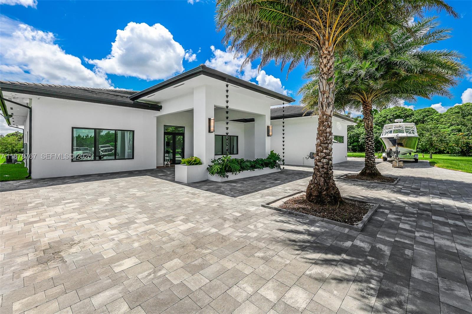 17950 Southwest 192nd Street Miami, FL 33187 - Photo 11 of 53 a front view of a house with garden