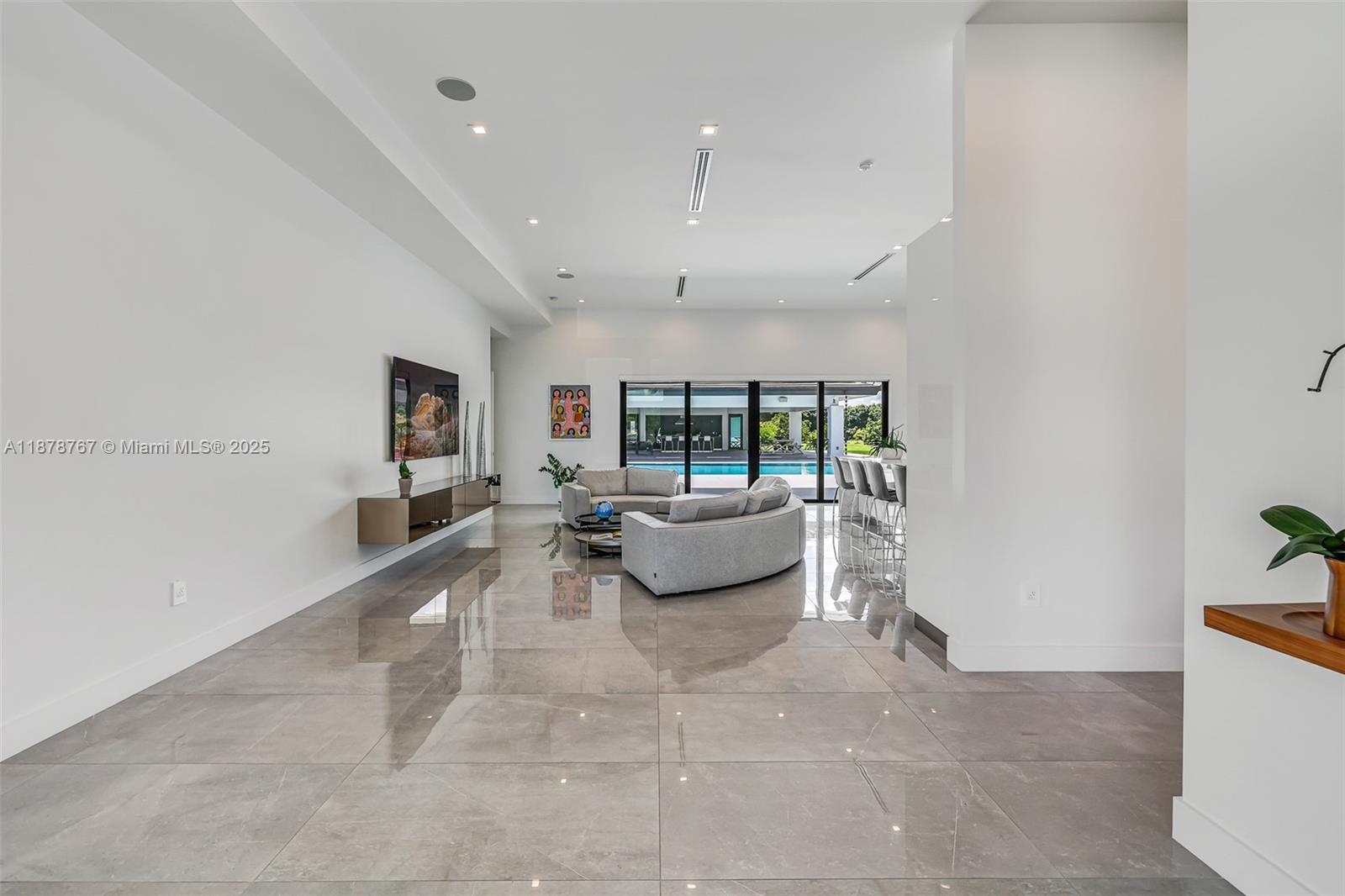 17950 Southwest 192nd Street Miami, FL 33187 - Photo 12 of 53 a living room with furniture and a flat screen tv