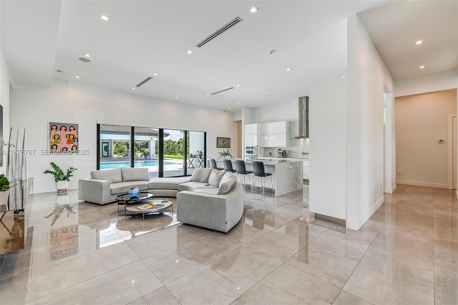 17950 Southwest 192nd Street Miami, FL 33187 - Photo 14 of 53 a living room with furniture and large windows