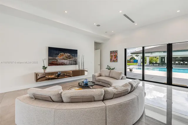 a kitchen with white cabinets and sink