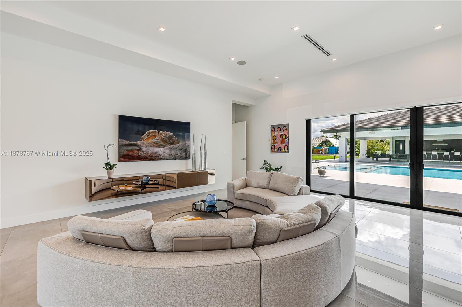 17950 Southwest 192nd Street Miami, FL 33187 - Photo 15 of 53 a living room with furniture and a flat screen tv