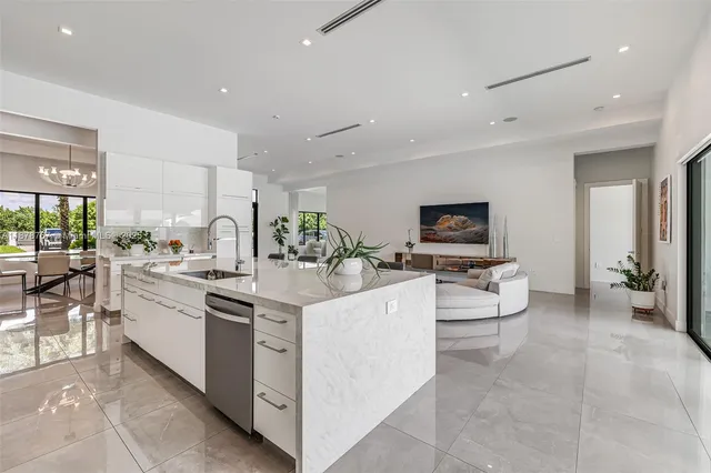 a view of kitchen with stainless steel appliances kitchen island granite countertop a stove and cabinets
