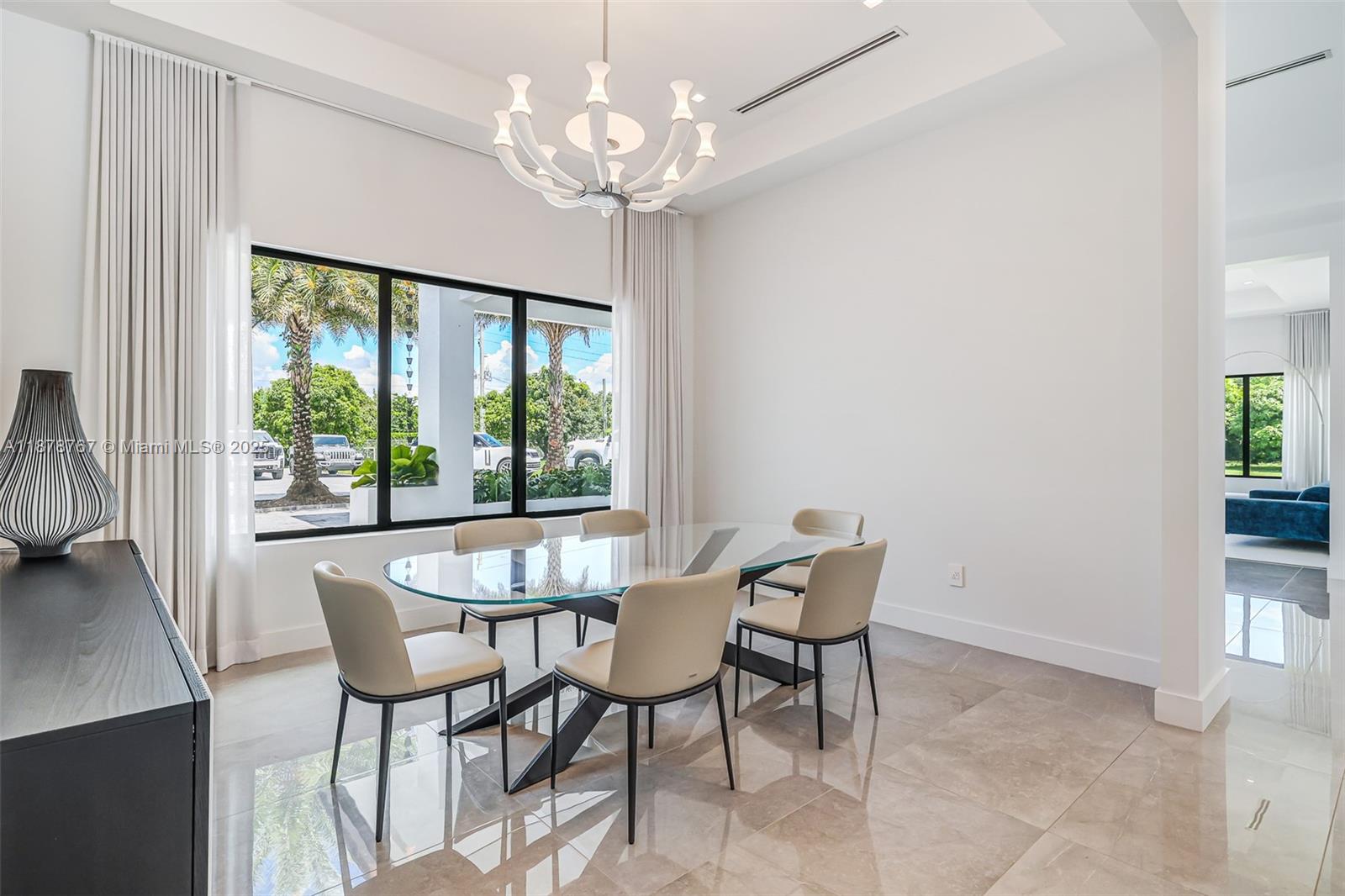 17950 Southwest 192nd Street Miami, FL 33187 - Photo 20 of 53 a dining room with furniture a chandelier and wooden floor