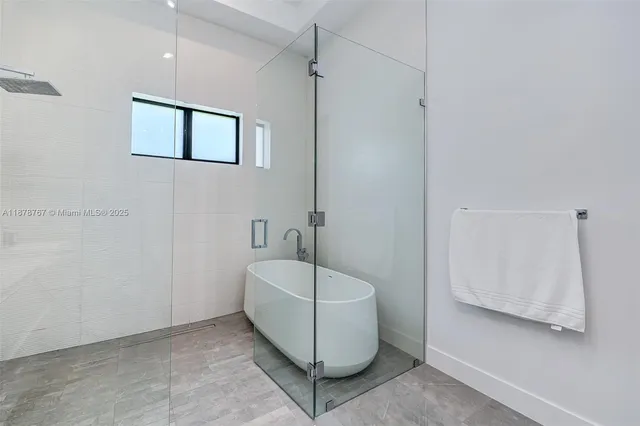 a bathroom with double vanity and a bathtub