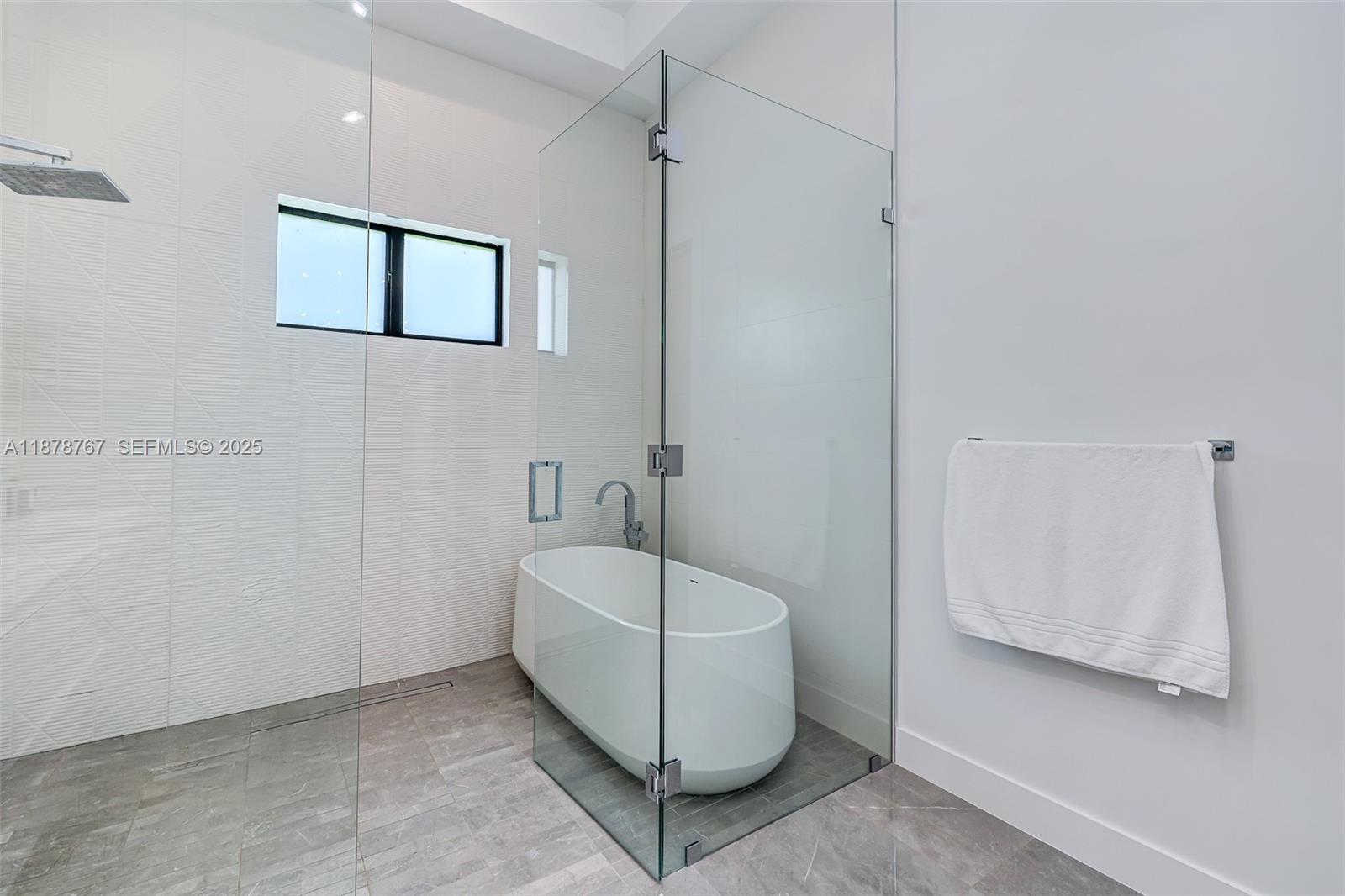 17950 Southwest 192nd Street Miami, FL 33187 - Photo 24 of 53 a bathroom with a bathtub and shower