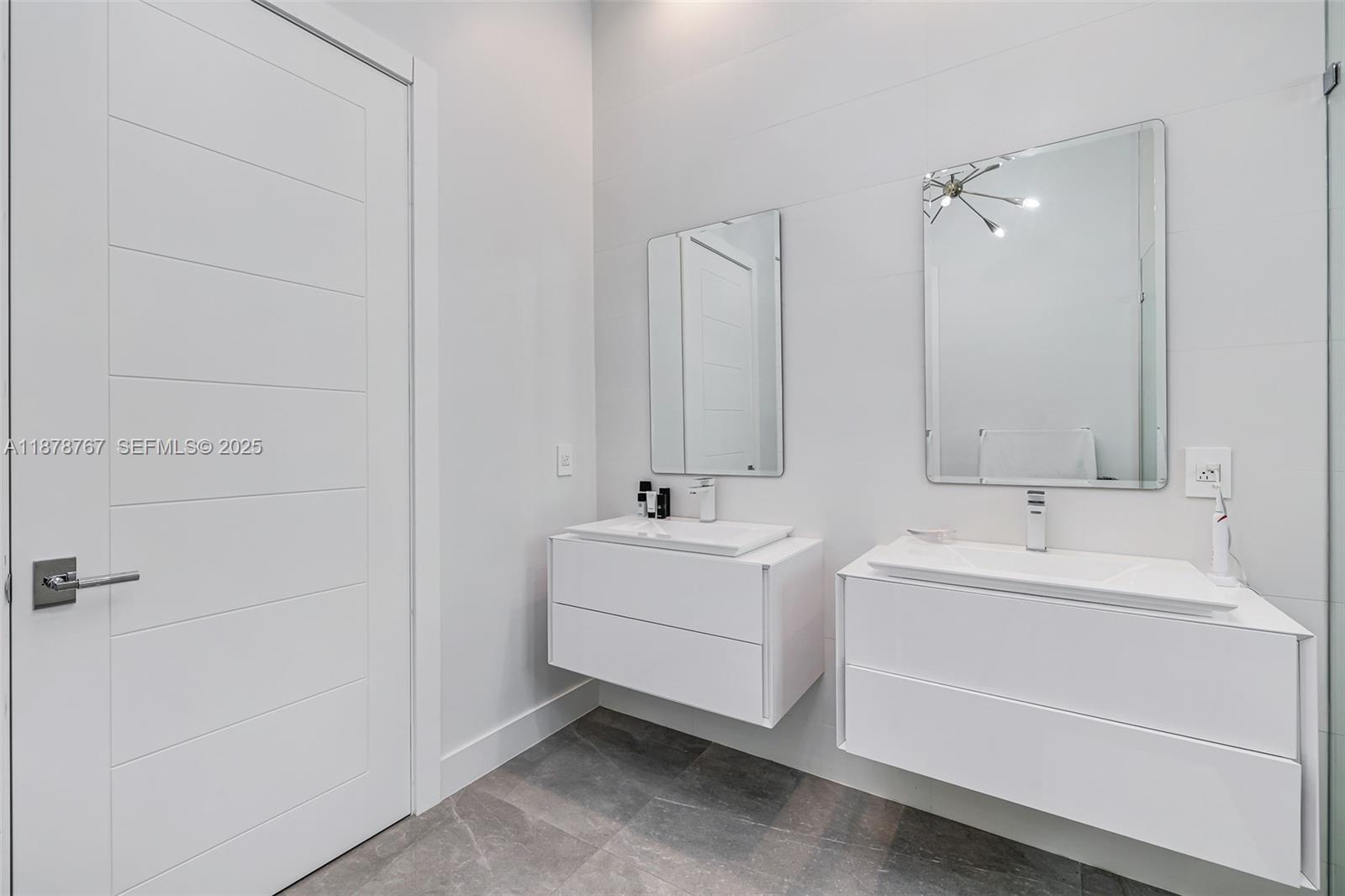 17950 Southwest 192nd Street Miami, FL 33187 - Photo 25 of 53 a bathroom with double vanity and a bathtub