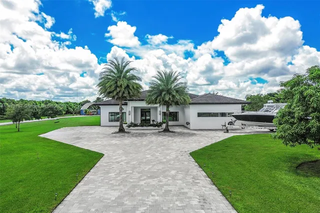 a view of a house with backyard and sitting area
