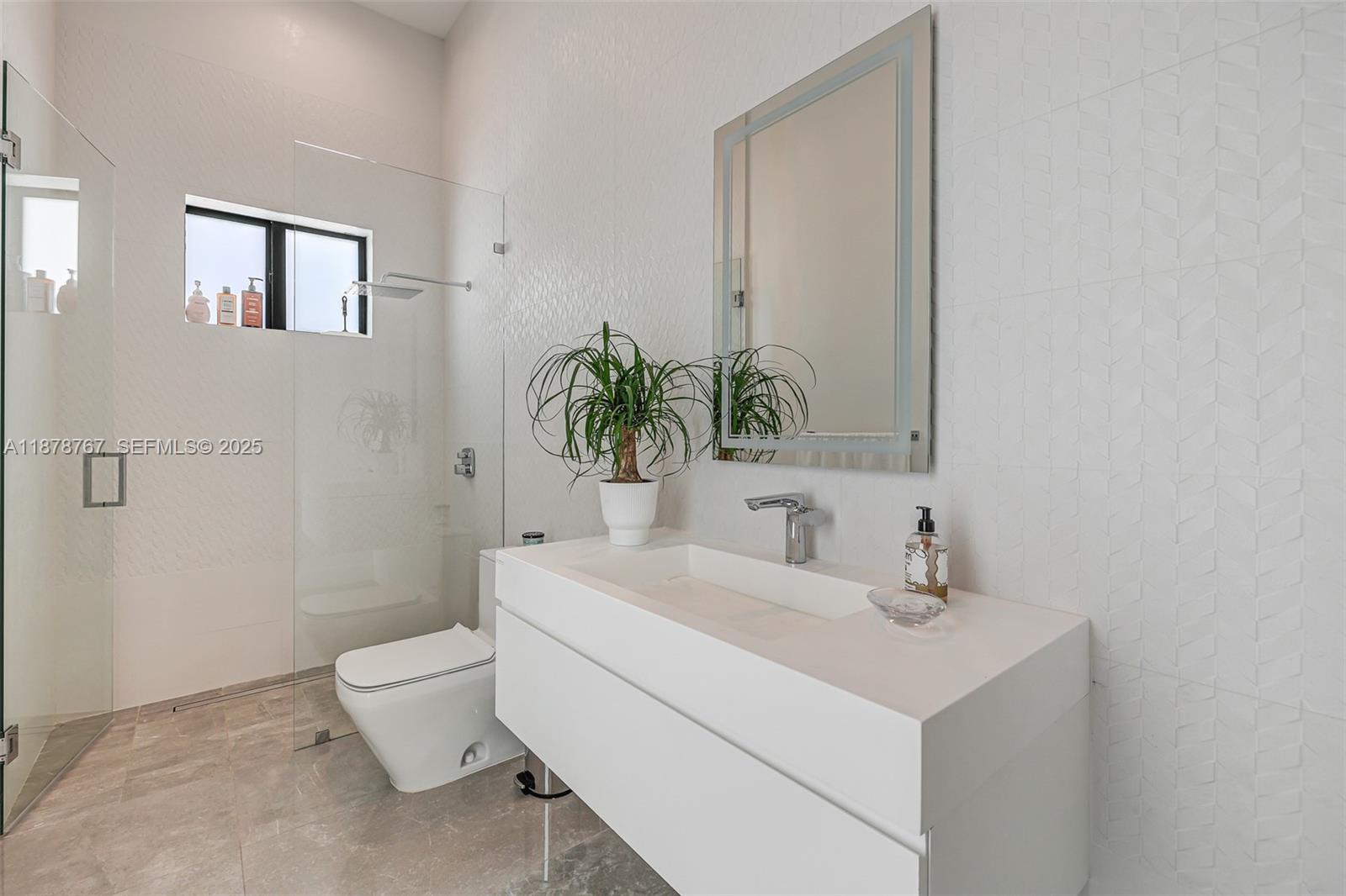 17950 Southwest 192nd Street Miami, FL 33187 - Photo 32 of 53 a bathroom with a toilet sink and mirror