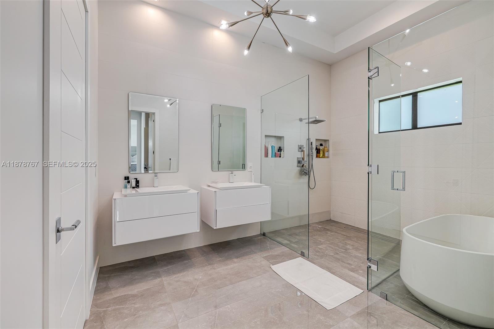 17950 Southwest 192nd Street Miami, FL 33187 - Photo 34 of 53 a bathroom with a sink a mirror and a bathtub