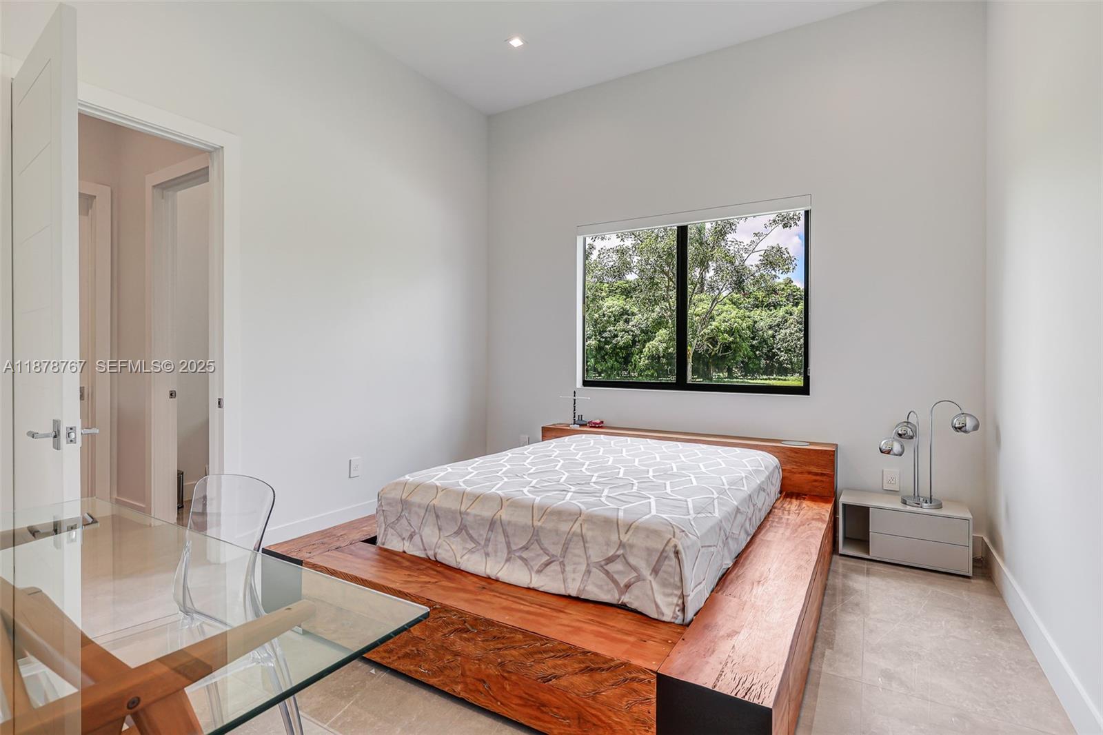 17950 Southwest 192nd Street Miami, FL 33187 - Photo 36 of 53 a bedroom with a bed and a table