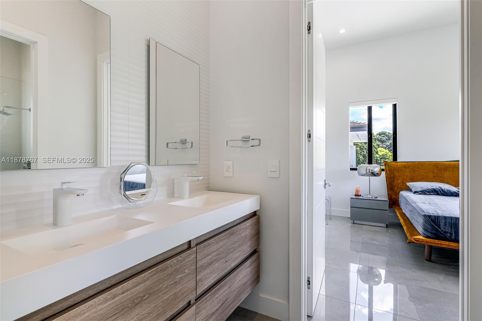 17950 Southwest 192nd Street Miami, FL 33187 - Photo 39 of 53 a en suite bathroom with a sink and a mirror