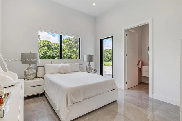 a spacious bedroom with a bed and a large window