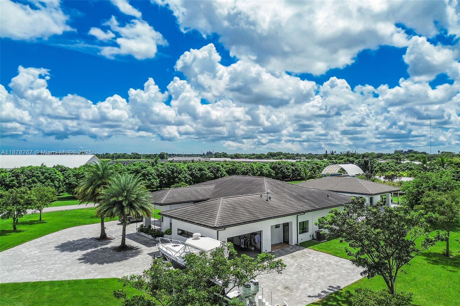 17950 Southwest 192nd Street Miami, FL 33187 - Photo 4 of 53 a view of a house with a yard plants and large tree
