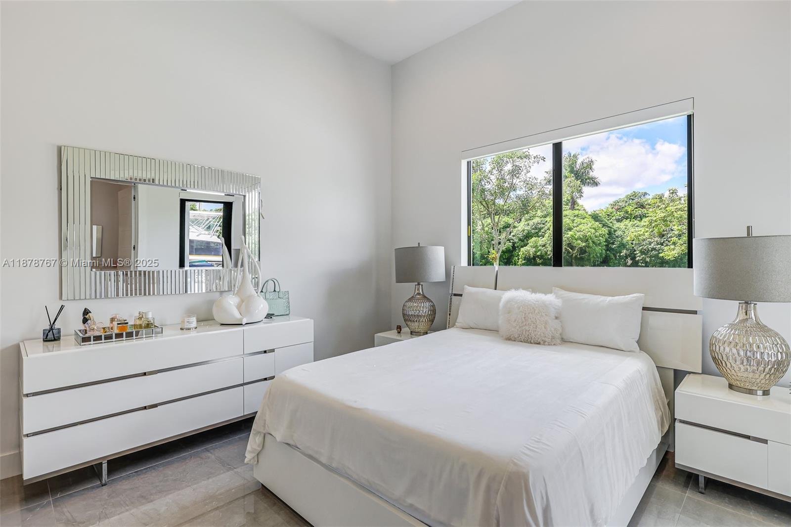 17950 Southwest 192nd Street Miami, FL 33187 - Photo 41 of 53 a bedroom with a bed a large mirror and window