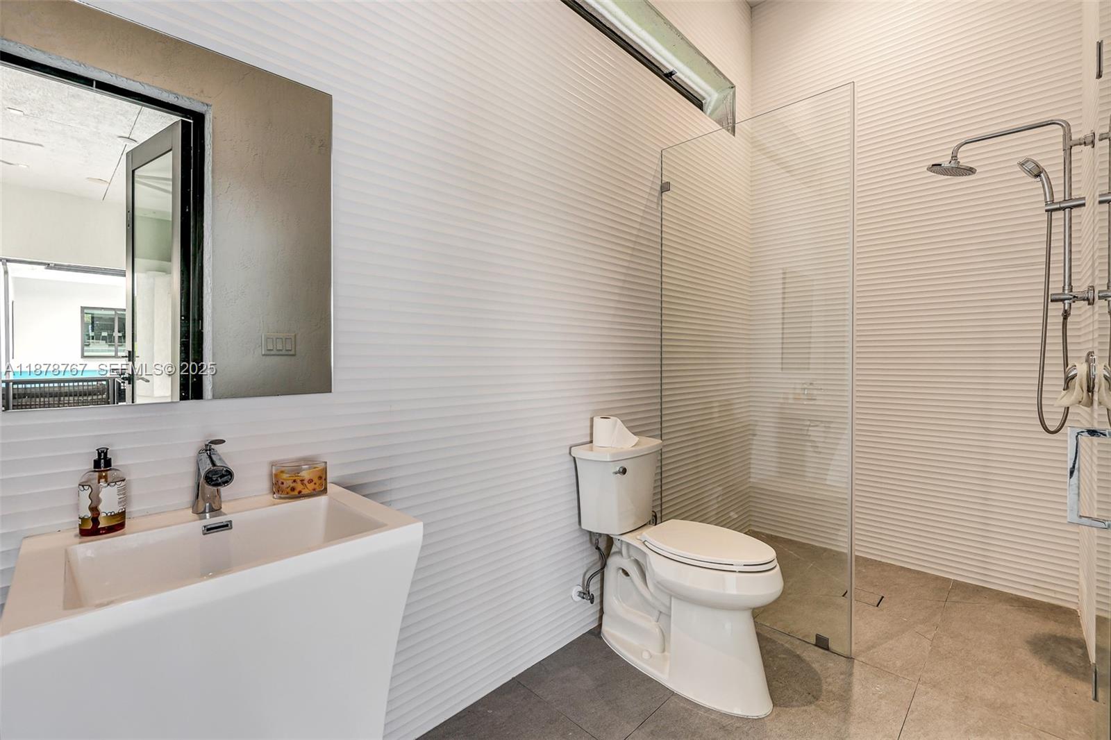 17950 Southwest 192nd Street Miami, FL 33187 - Photo 42 of 53 a white toilet sitting next to a bathroom sink