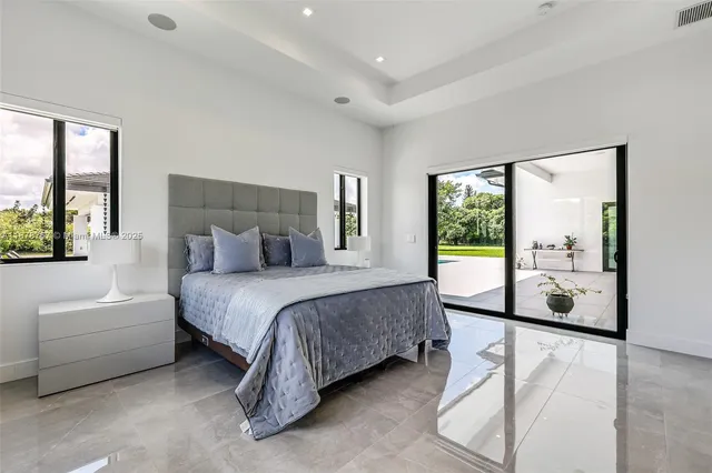 a outdoor space with lots of white furniture and a fountain