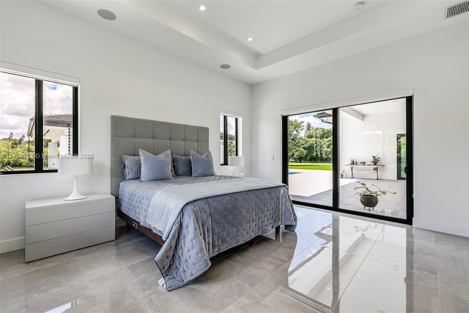 17950 Southwest 192nd Street Miami, FL 33187 - Photo 43 of 53 a spacious bedroom with a bed and a large window