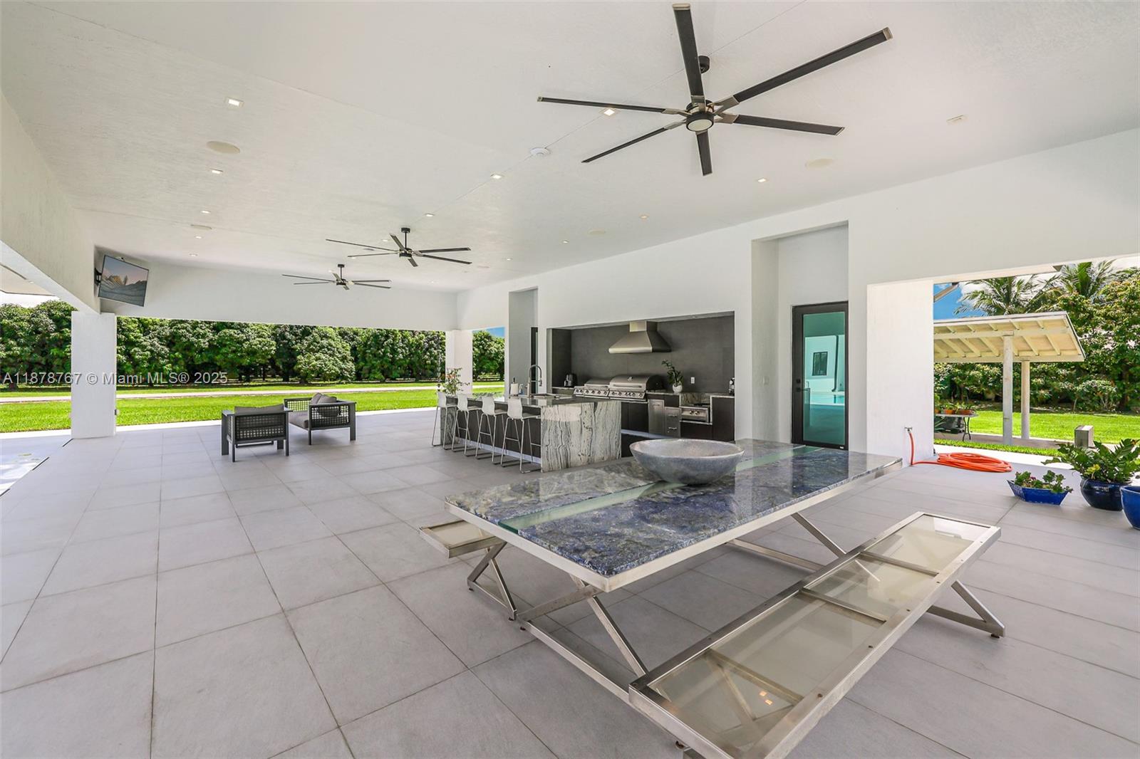 17950 Southwest 192nd Street Miami, FL 33187 - Photo 46 of 53 a outdoor space with lots of white furniture and a fountain