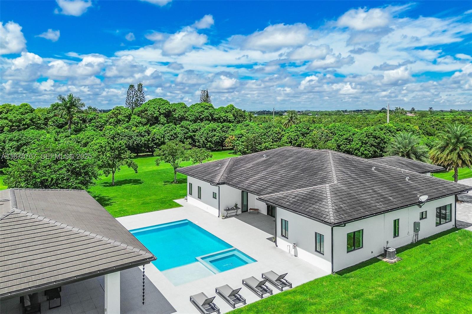 17950 Southwest 192nd Street Miami, FL 33187 - Photo 5 of 53 a aerial view of a house with a yard table and chairs