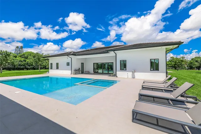 a view of a patio with swimming pool table and chairs