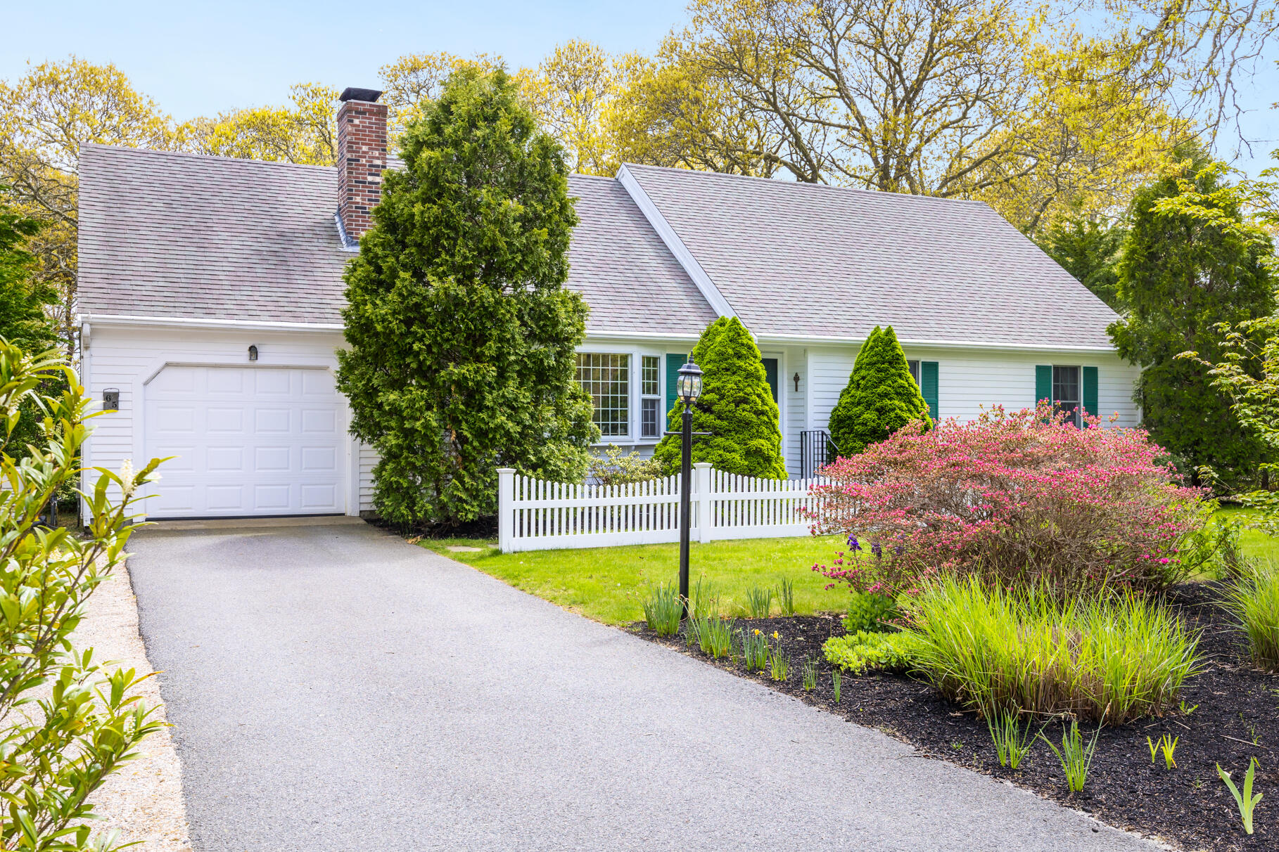 65 Continental Drive Harwich, MA 02645 - Photo 1 of 34 a view of a house with a yard and potted plants