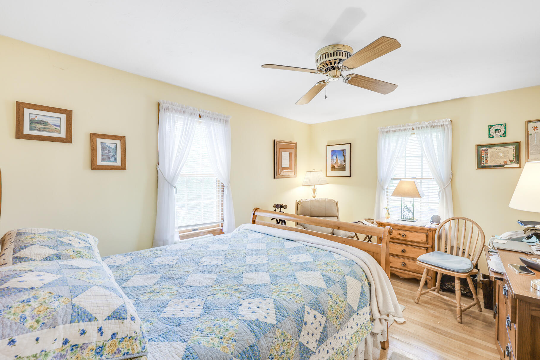 65 Continental Drive Harwich, MA 02645 - Photo 23 of 34 a bedroom with a bed and wooden floor